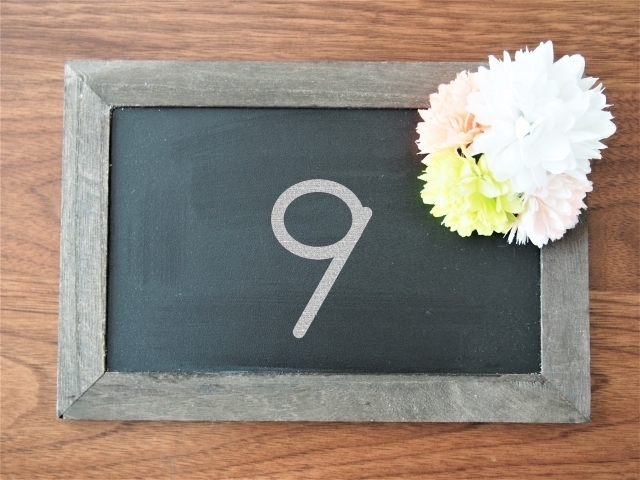 パステルカラーの花飾りがついた小さなボードに9と書かれている